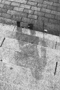 The shadow of the Hiroshima resident seated on the Sumitomo bank steps.